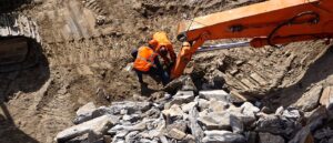 Analyzing PFAS in Bedrock Construction Workers examining bedrock as construction begins.